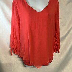 Peach long sleeve blouse open shoulder sleeves.